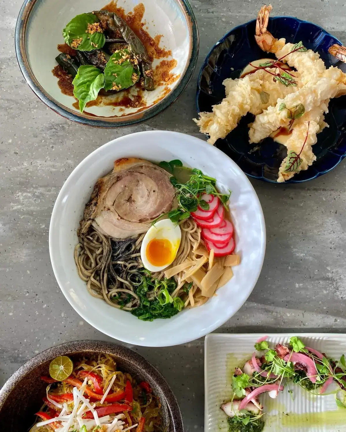 Shared plates spread across a Star Noodle table