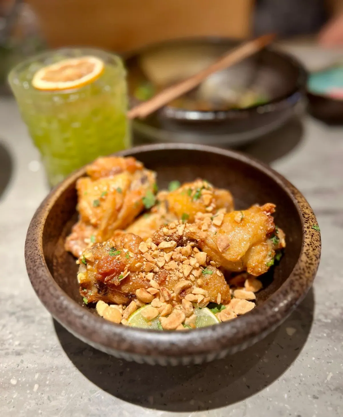 Nuoc cham chicken wings with peanuts, mint, and cilantro